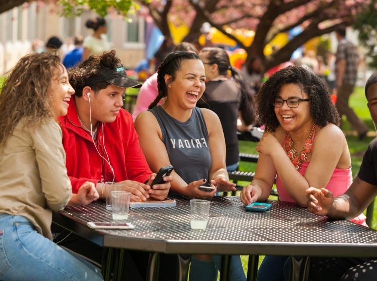 Students Sitting at Table in the Quad